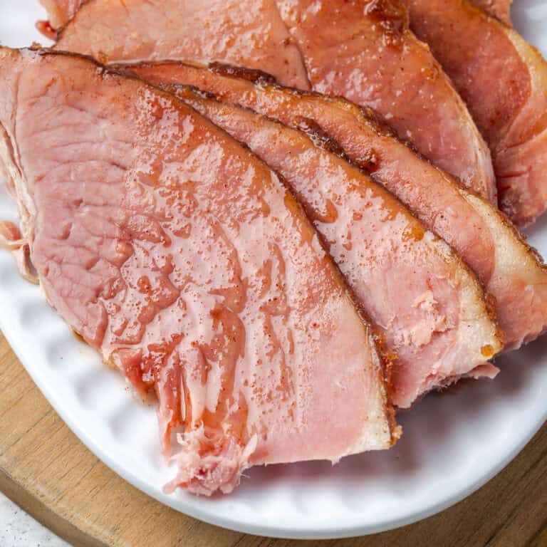 Slices of baked ham on a serving platter.
