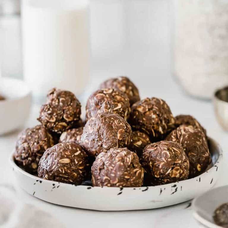 A stack of nutella energy balls on a white plate.