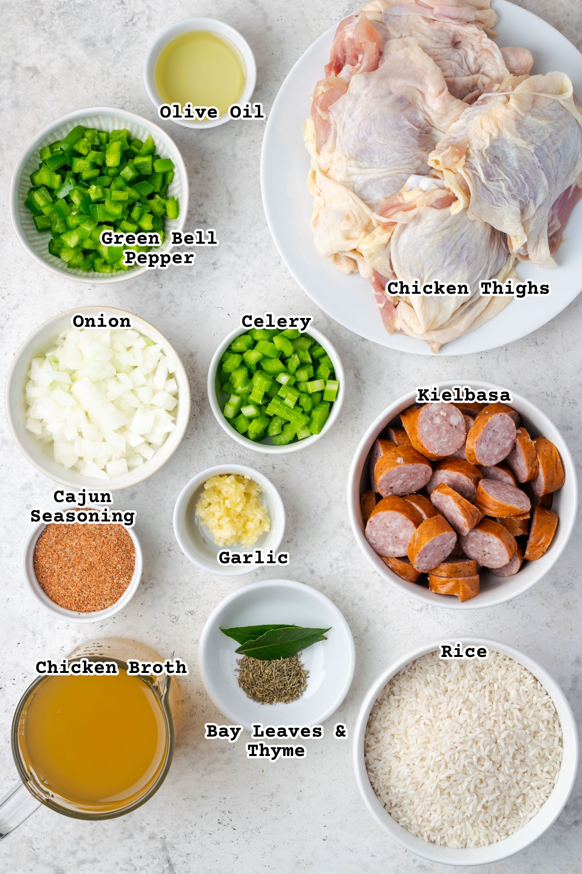 Ingredients for chicken and sausage jambalaya sitting on a countertop. 