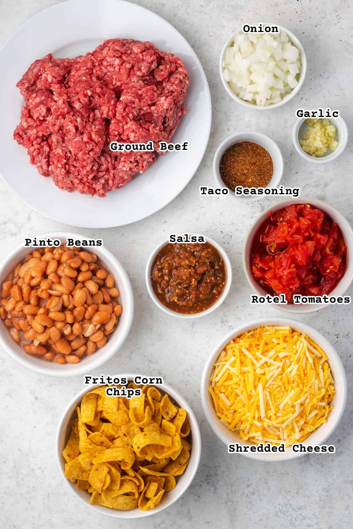 Ingredients for Frito taco casserole sitting on a countertop.