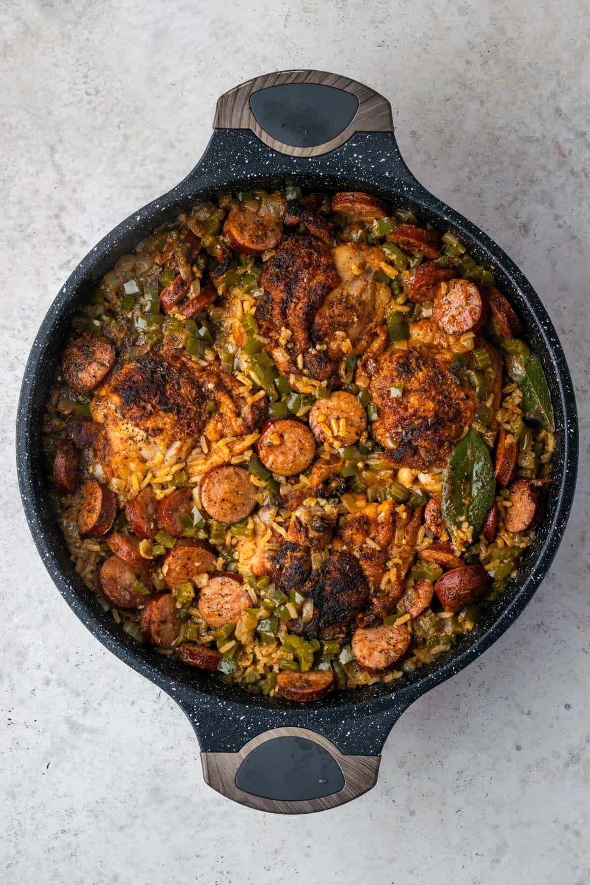 A large pan of cooked chicken and sausage jambalaya.