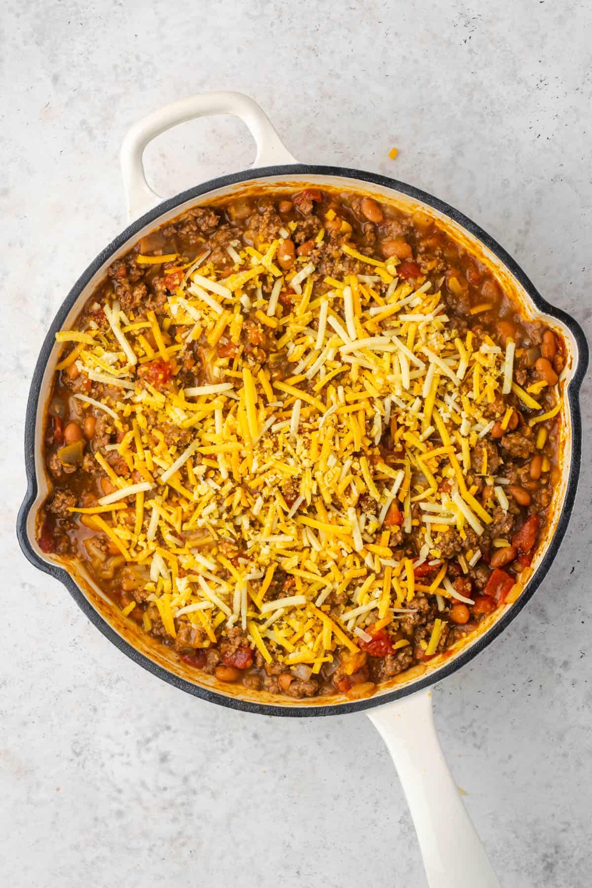 Shredded cheese sprinkled over the top of the taco chili. 
