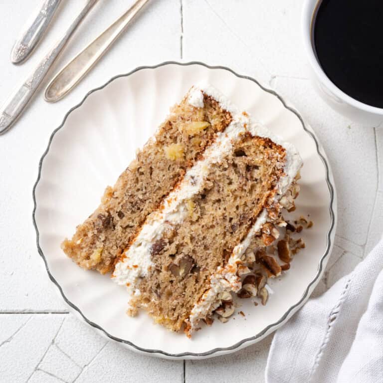 A slice of gluten free hummingbird cake served on a small dessert plate.