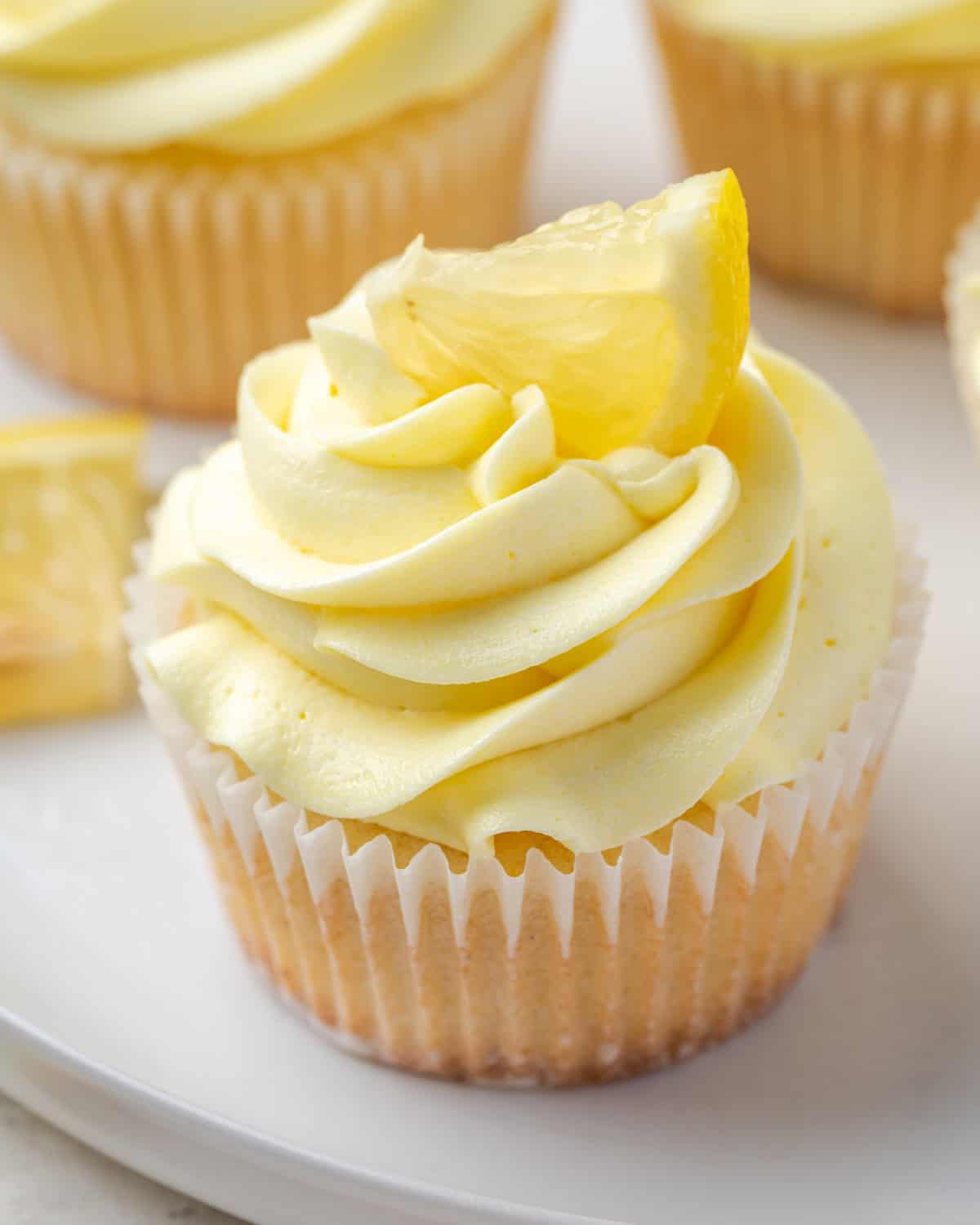 A single gluten free lemon cupcake topped with lemon frosting. 