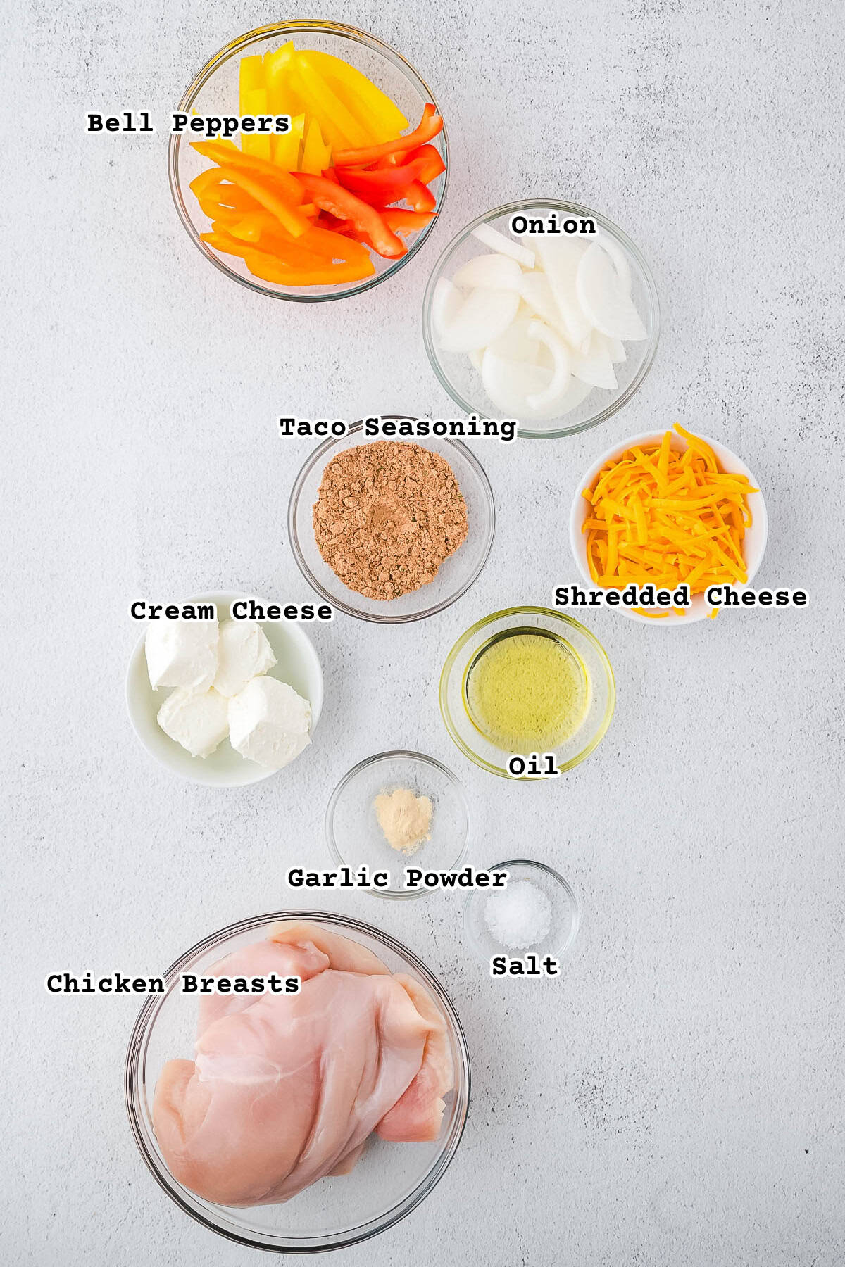 Ingredients for fajita stuffed chicken breasts on a white counter.