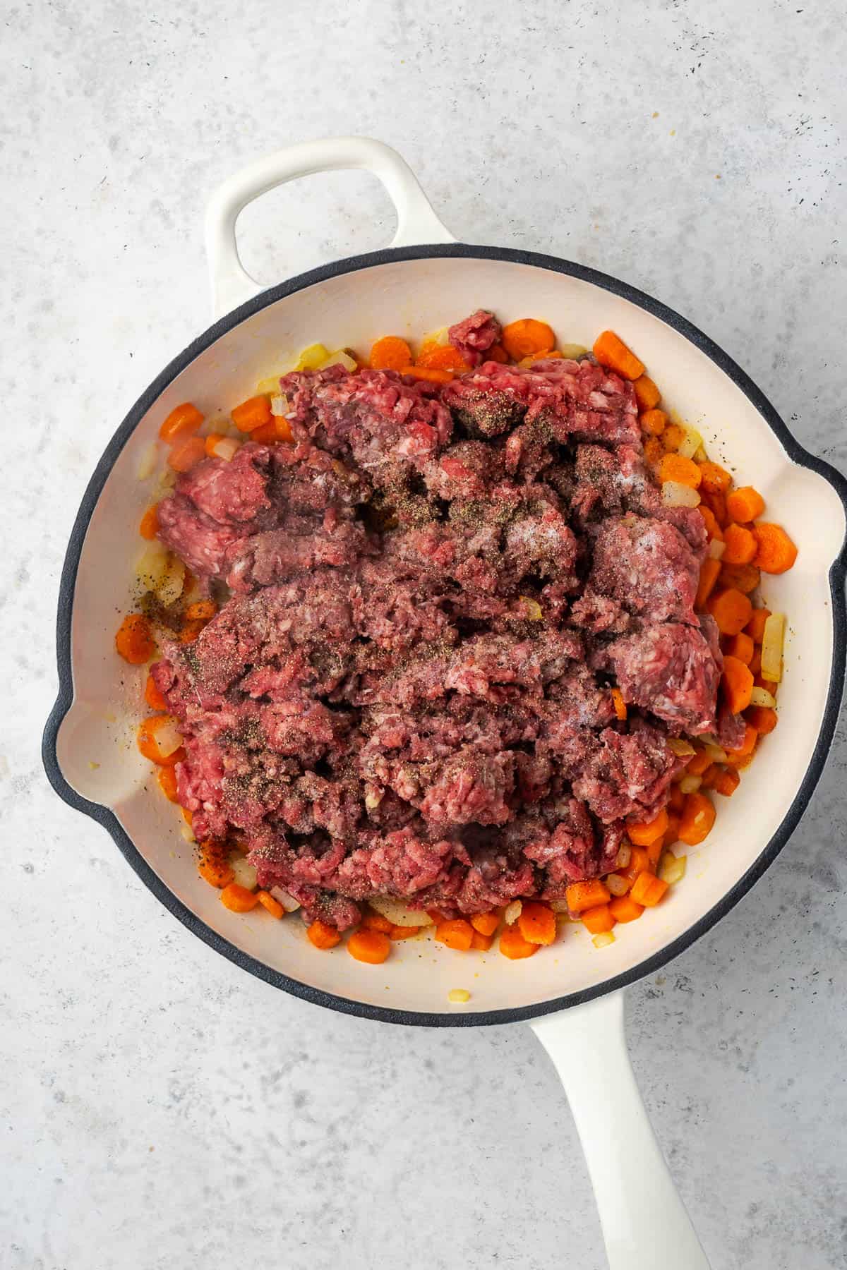 Ground beef added to the skillet with the sauteed vegetables. 