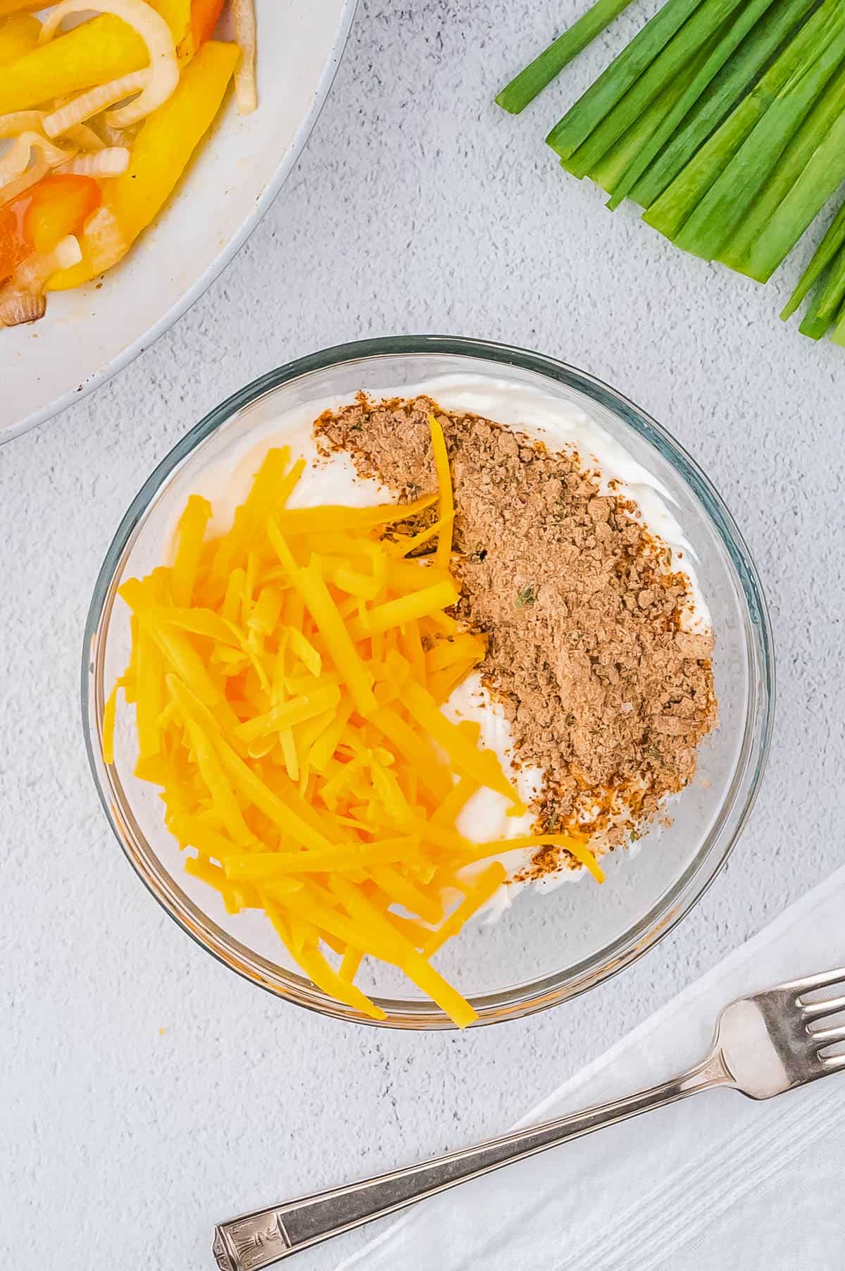 Cream cheese, shredded cheddar cheese and taco seasoning in a small bowl. 