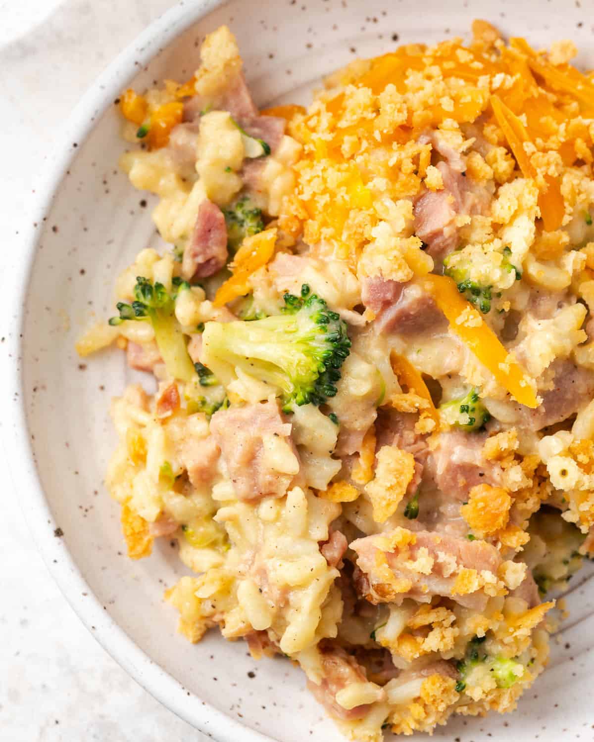 A serving of ham broccoli and rice casserole on a small plate.
