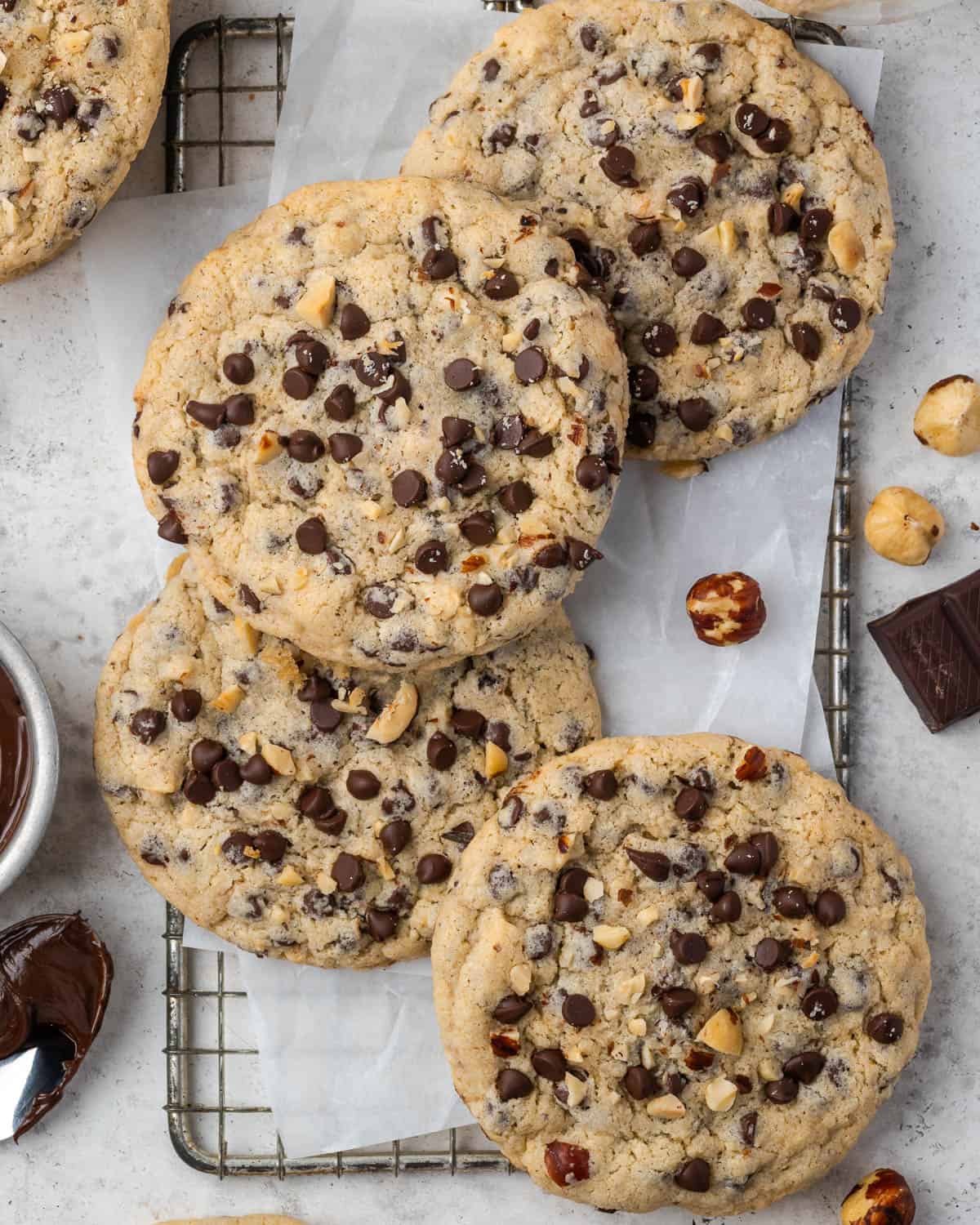 Several Nutella stuffed chocolate chip cookies on a wire rack. 