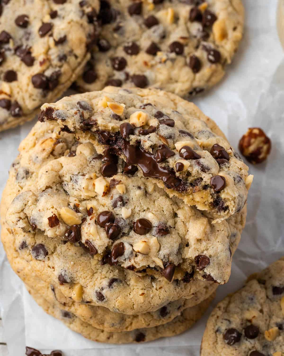 A stack of Nutella stuffed cookies with one cookie broken in half showing the Nutella filling inside.