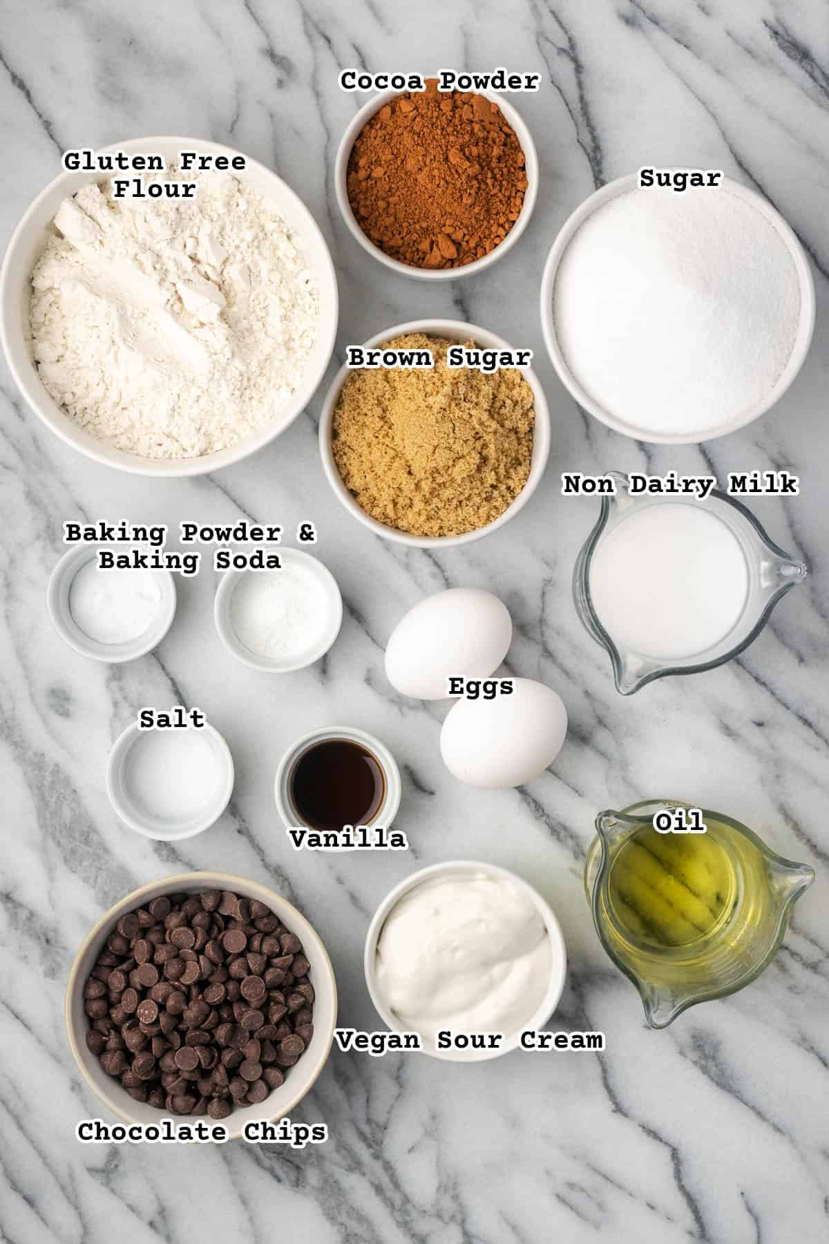 Ingredients for gluten free chocolate muffins sitting on a marble counter. 