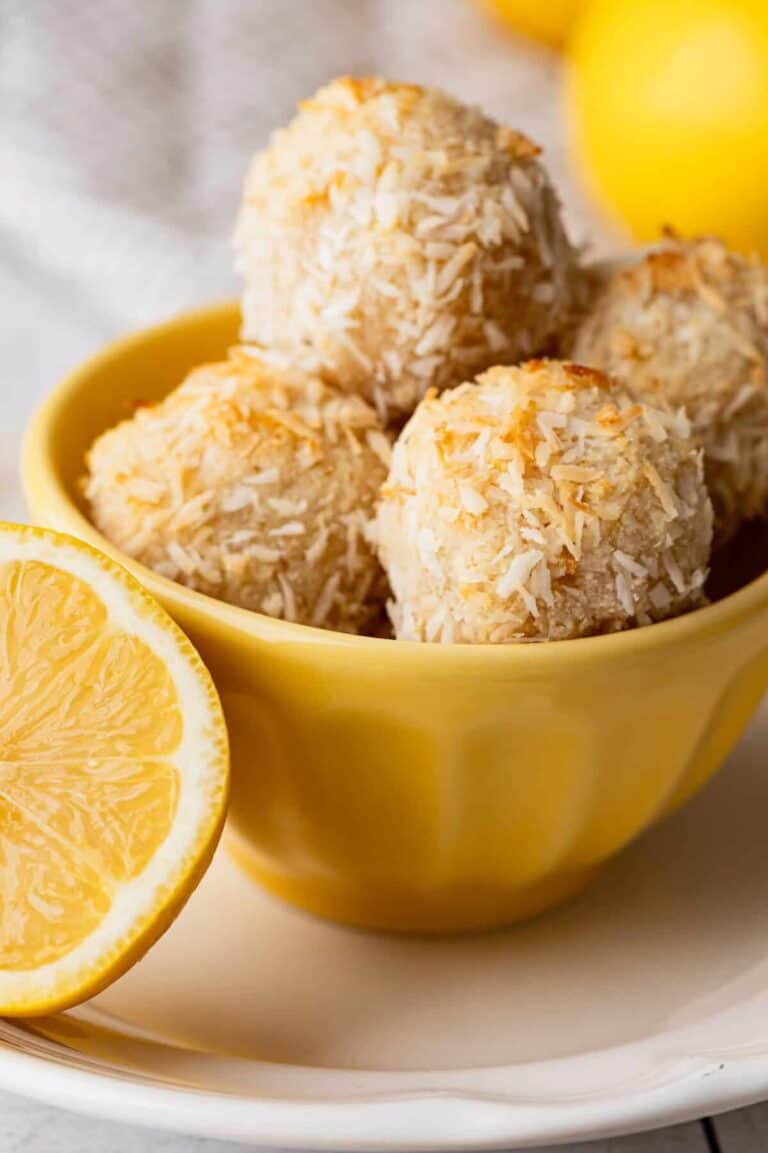 Several lemon and coconut macaroons in a yellow bowl. 