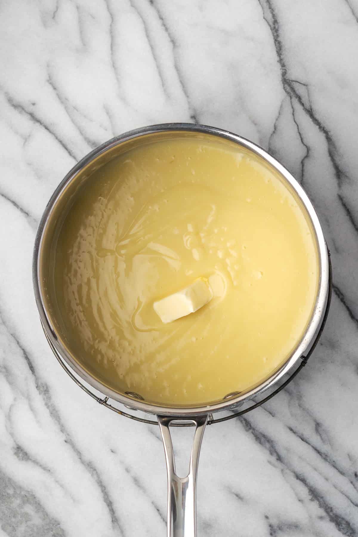 A pat of butter added to the saucepan with the cooked pudding. 