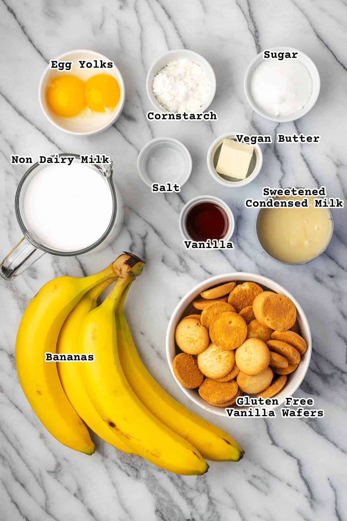 Ingredients for a gluten free and dairy free banana pudding sitting on a marble counter. 