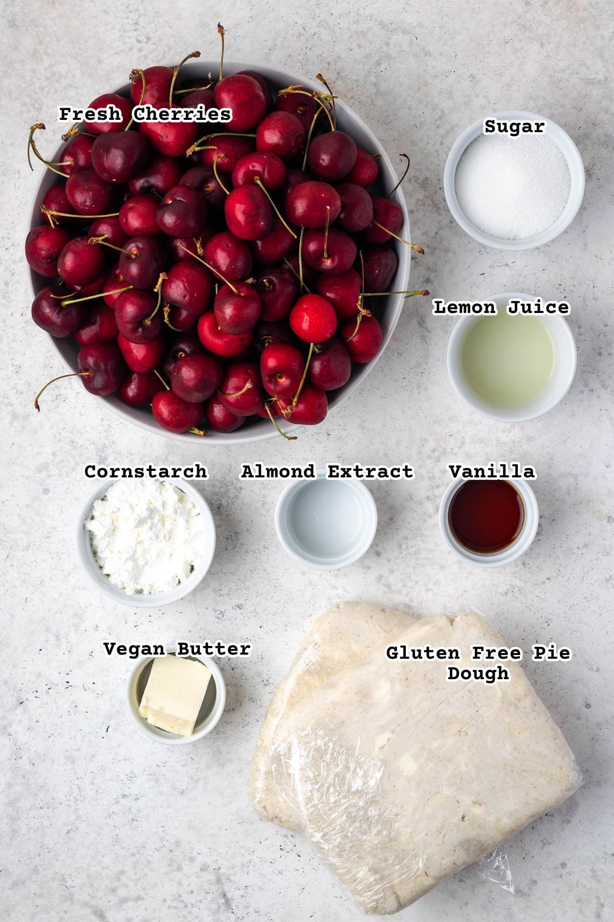 Ingredients for a gluten free cherry pie on a white countertop. 