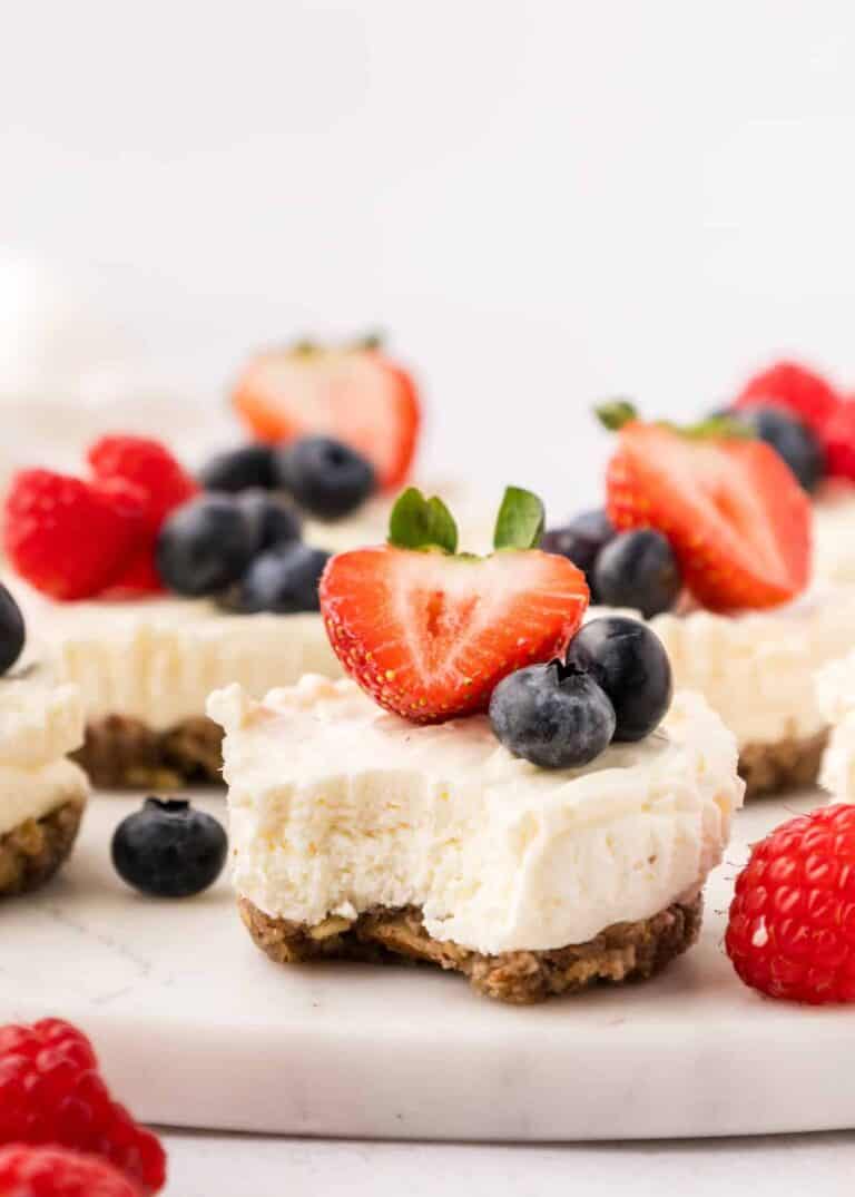 A mini gluten free cheesecake with a bite taken out.