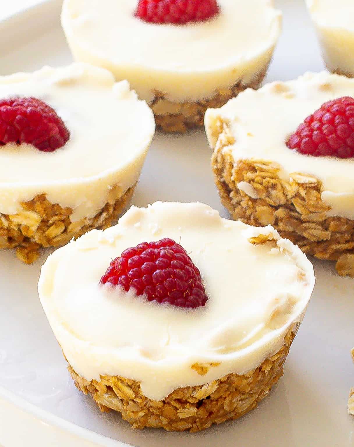 White chocolate oat cups topped with raspberries.
