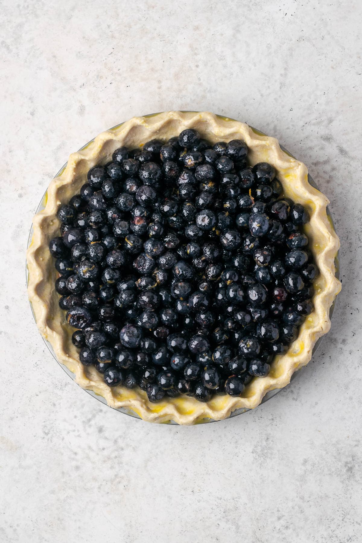 Blueberry filling poured into a frozen pie shell.