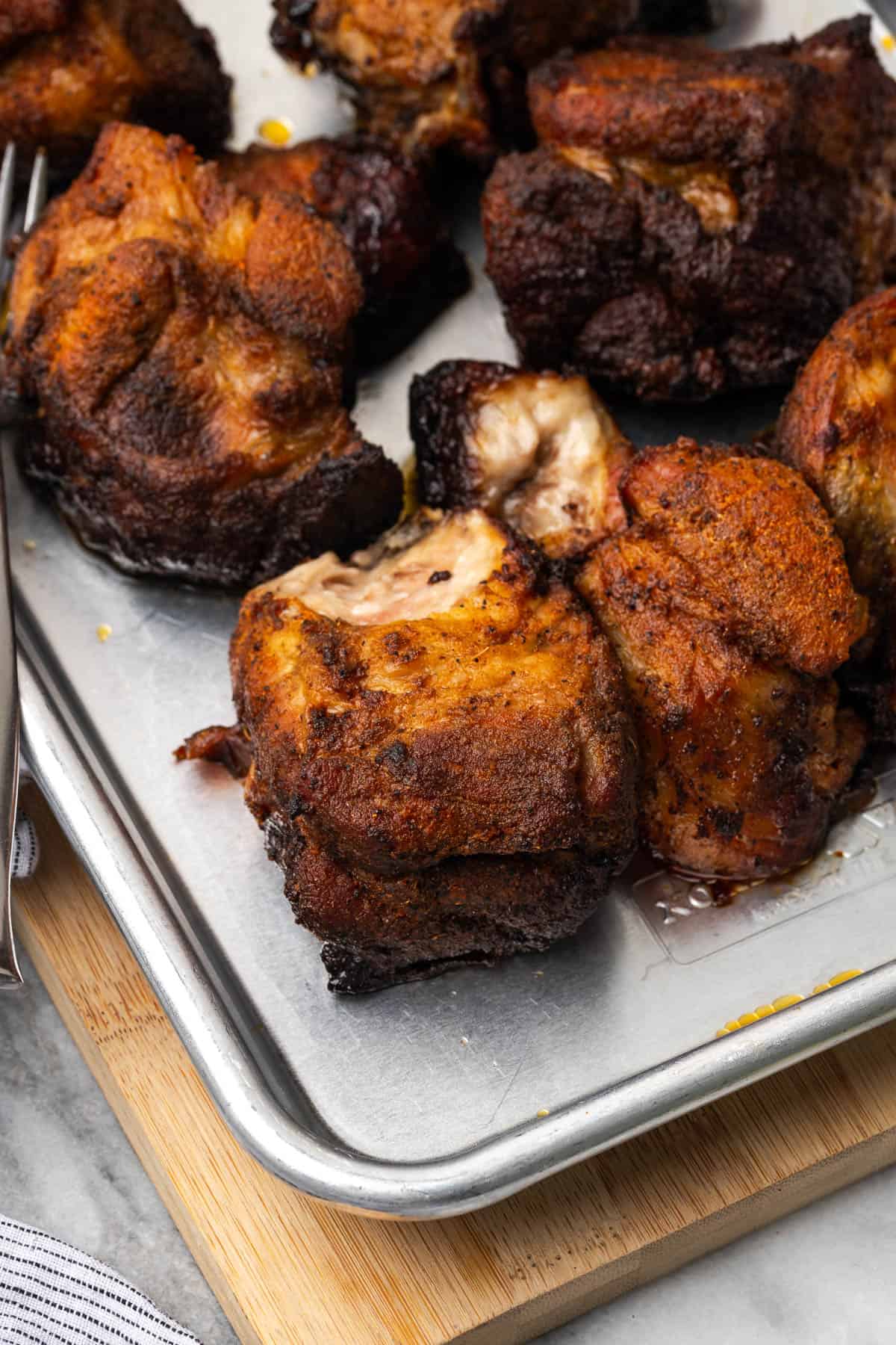 Cooked pork butt sitting on a metal baking tray.
