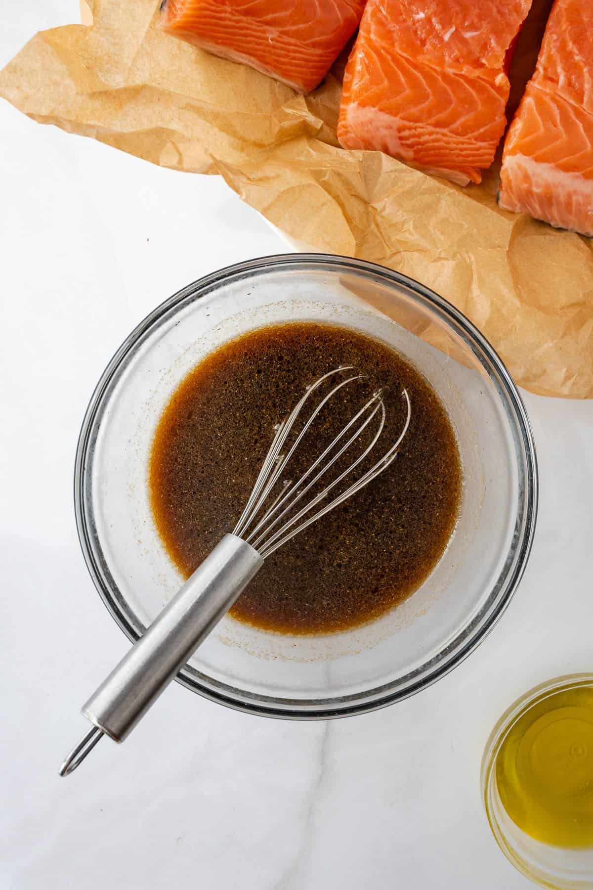 Teriyaki marinade being whisked together in a small glass bowl.