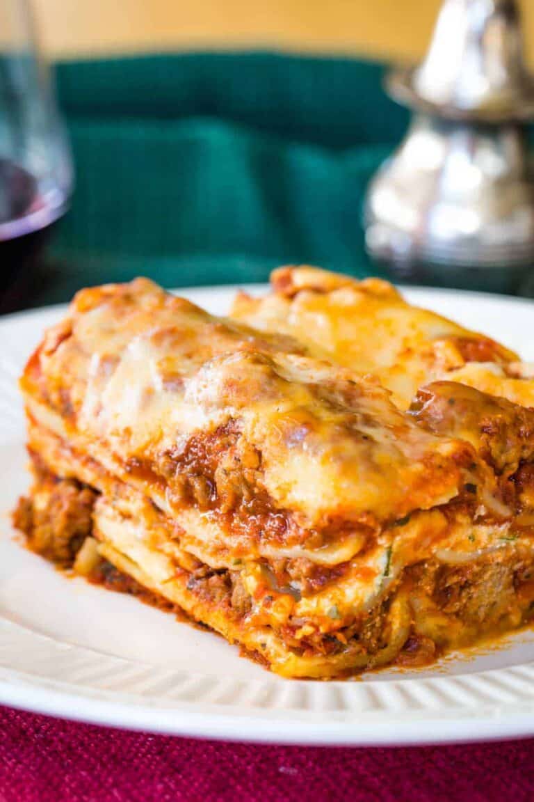 A slice of meat lasagna on a small serving plate.