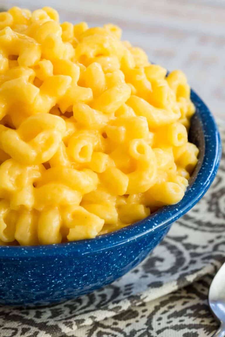 A bowl of gluten free macaroni and cheese sitting on a table. 