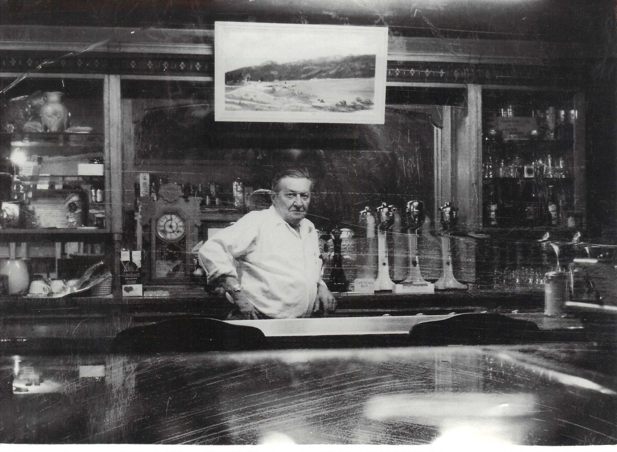 Charlie Stiburek leaning against the soda counter of the Stiburek bakery in Cascade, Idaho.