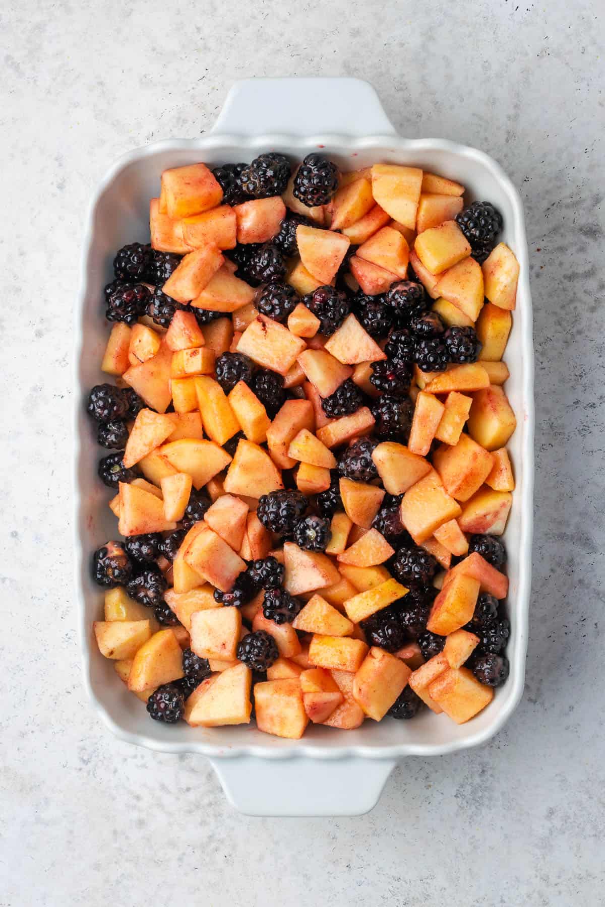 Fruit mixture spread in a casserole dish.
