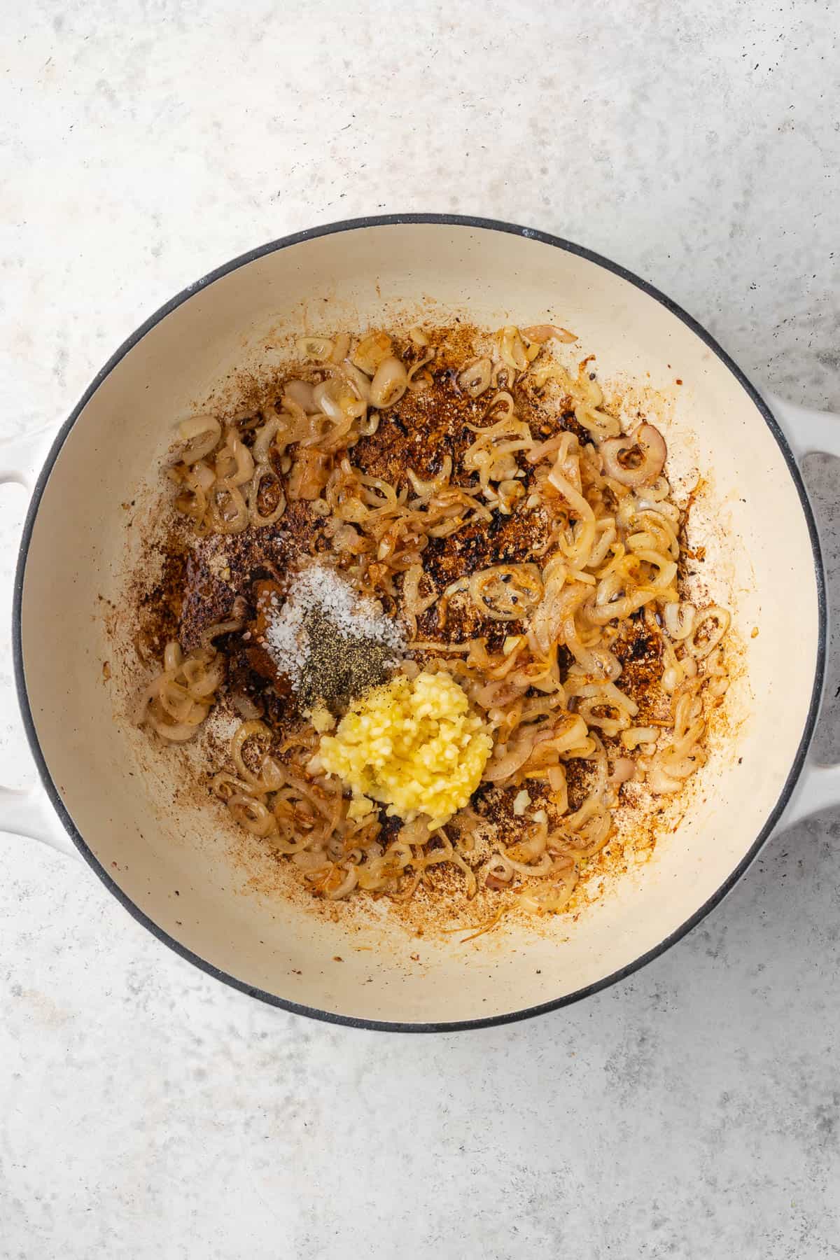 Minced garlic and spices added to the sauteed shallots.