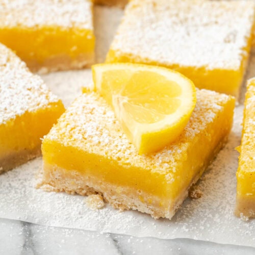 A gluten free lemon bar topped with a slice of lemon.