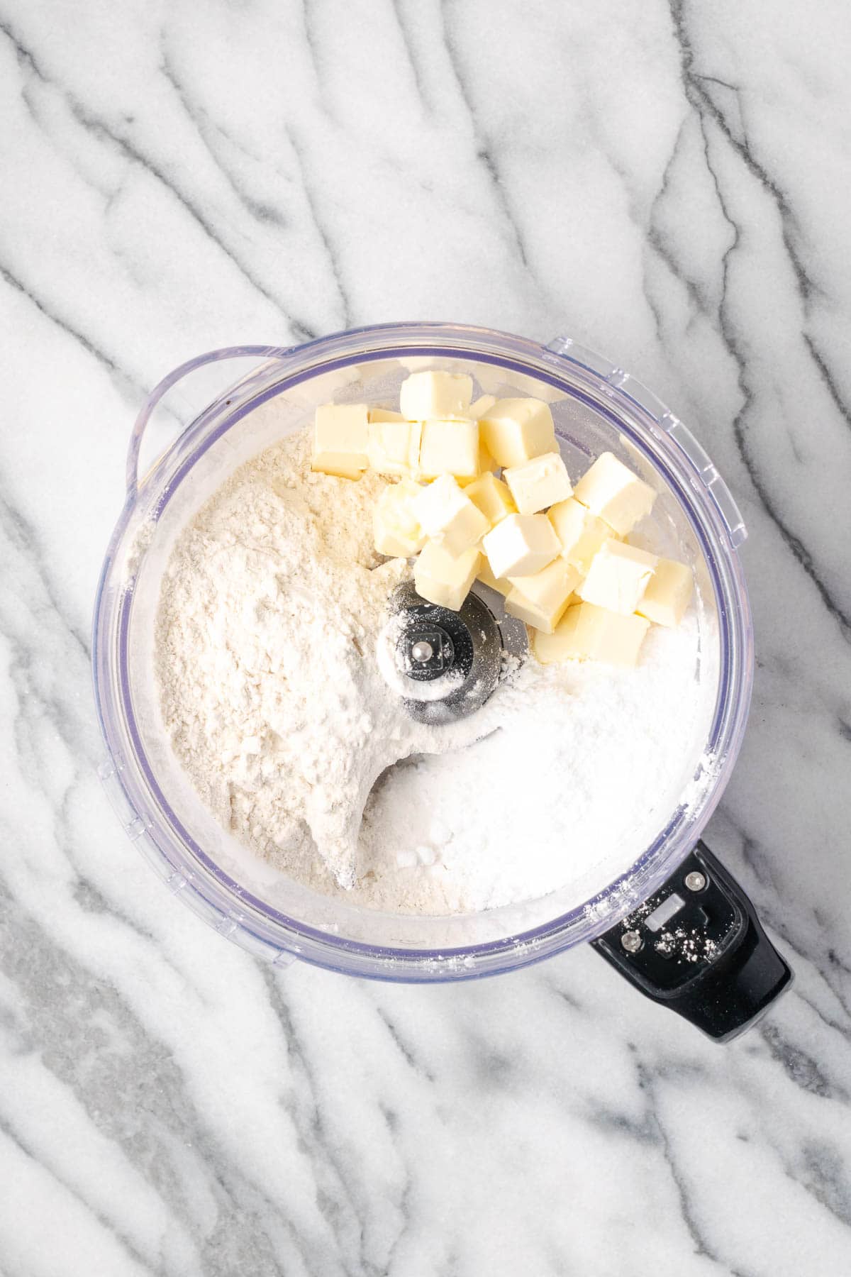 Gluten free flour, powdered sugar, butter and salt combined in a food processor.