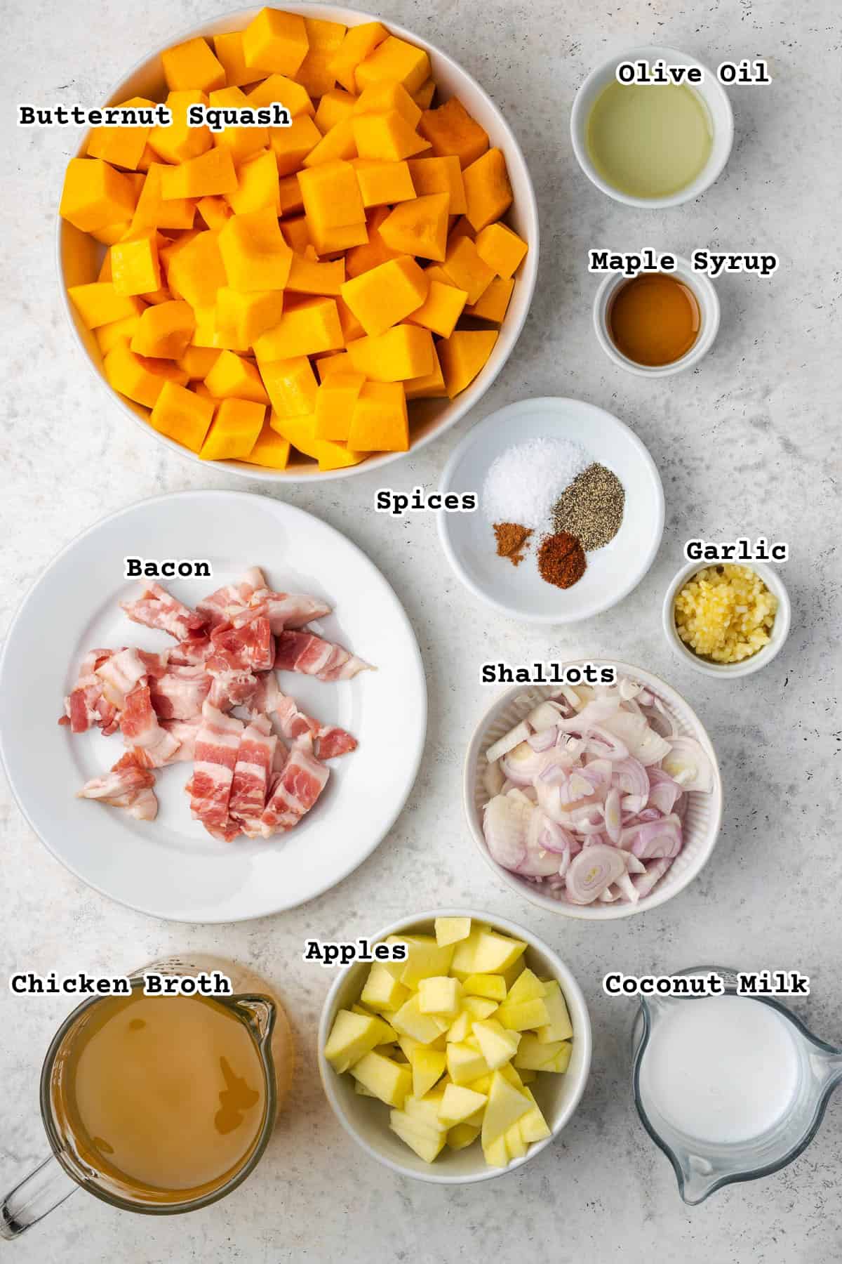 Ingredients for butternut squash and apple soup sitting on a white counter.