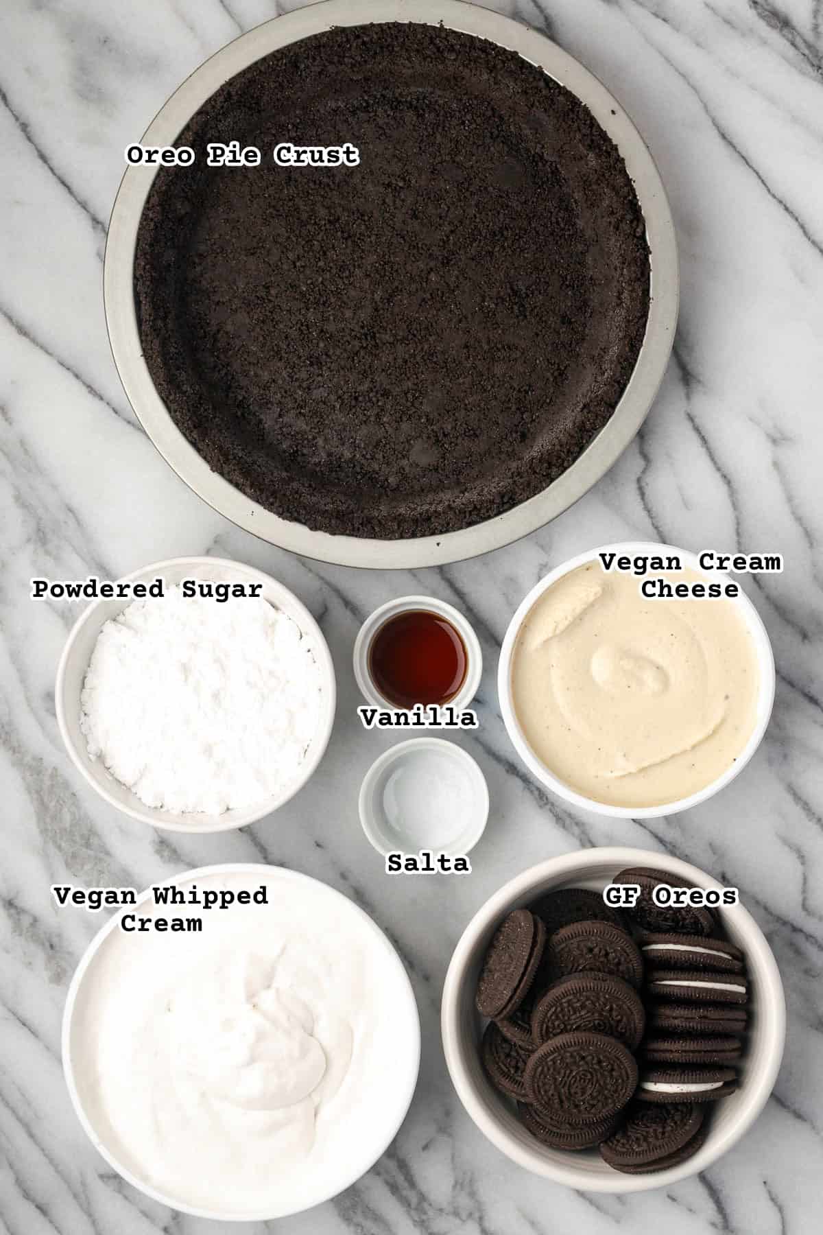 Ingredients for an Oreo pie sitting on a marble counter.