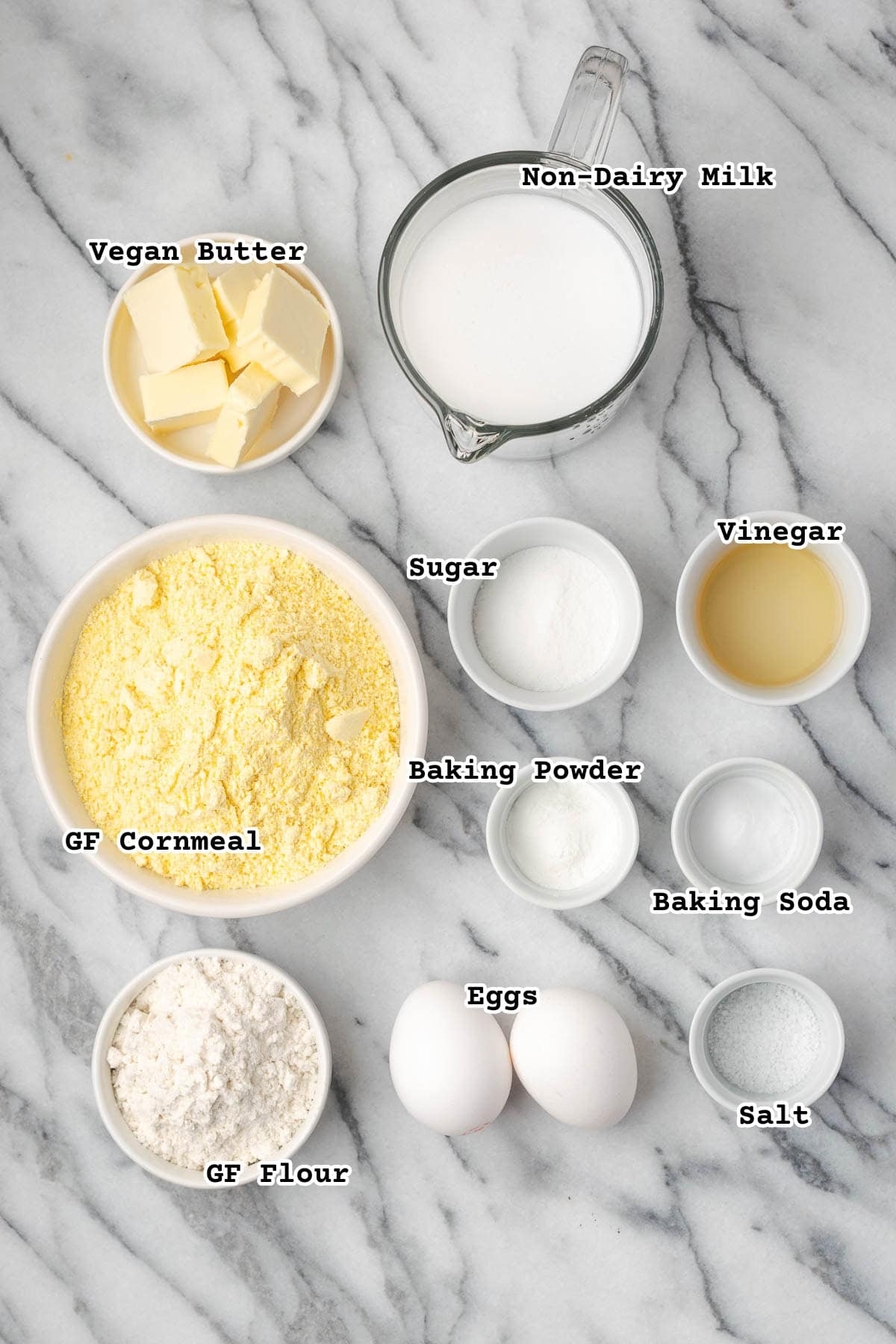 Ingredients for southern style cornbread sitting on a marble counter.