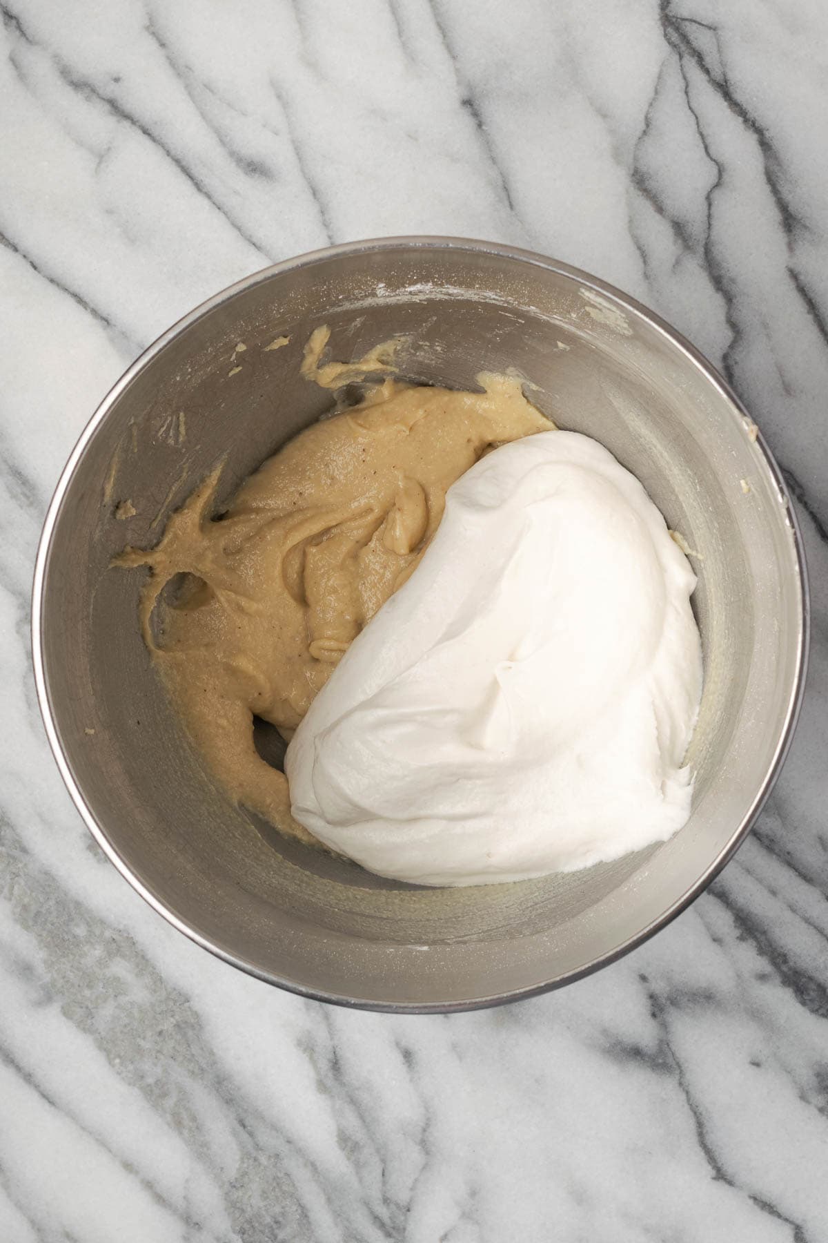 Whipped cream being folded into the cream cheese mixture.