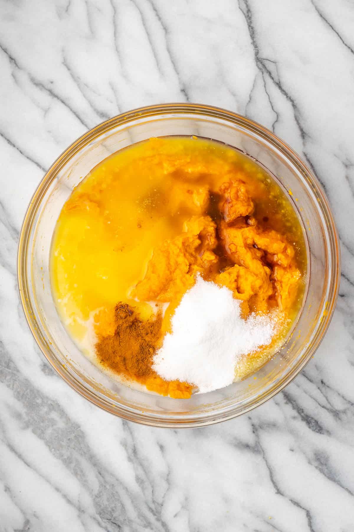 Sweet potatoes, butter, sugar, milk, eggs, maple syrup, vanilla, salt and cinnamon combined in a large mixing bowl.