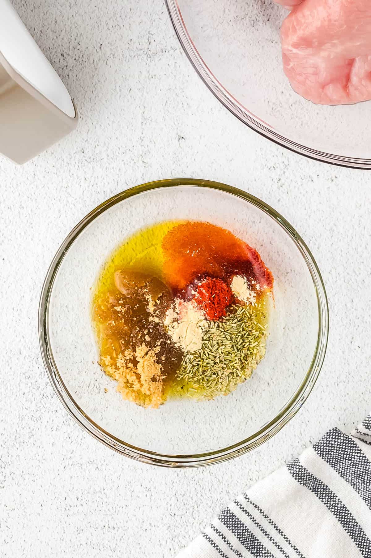 Brown sugar, herbs, spices and olive oil in a small mixing bowl.