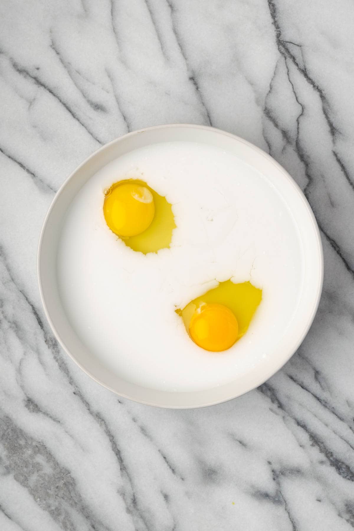 Egg and milk combined in a shallow bowl.