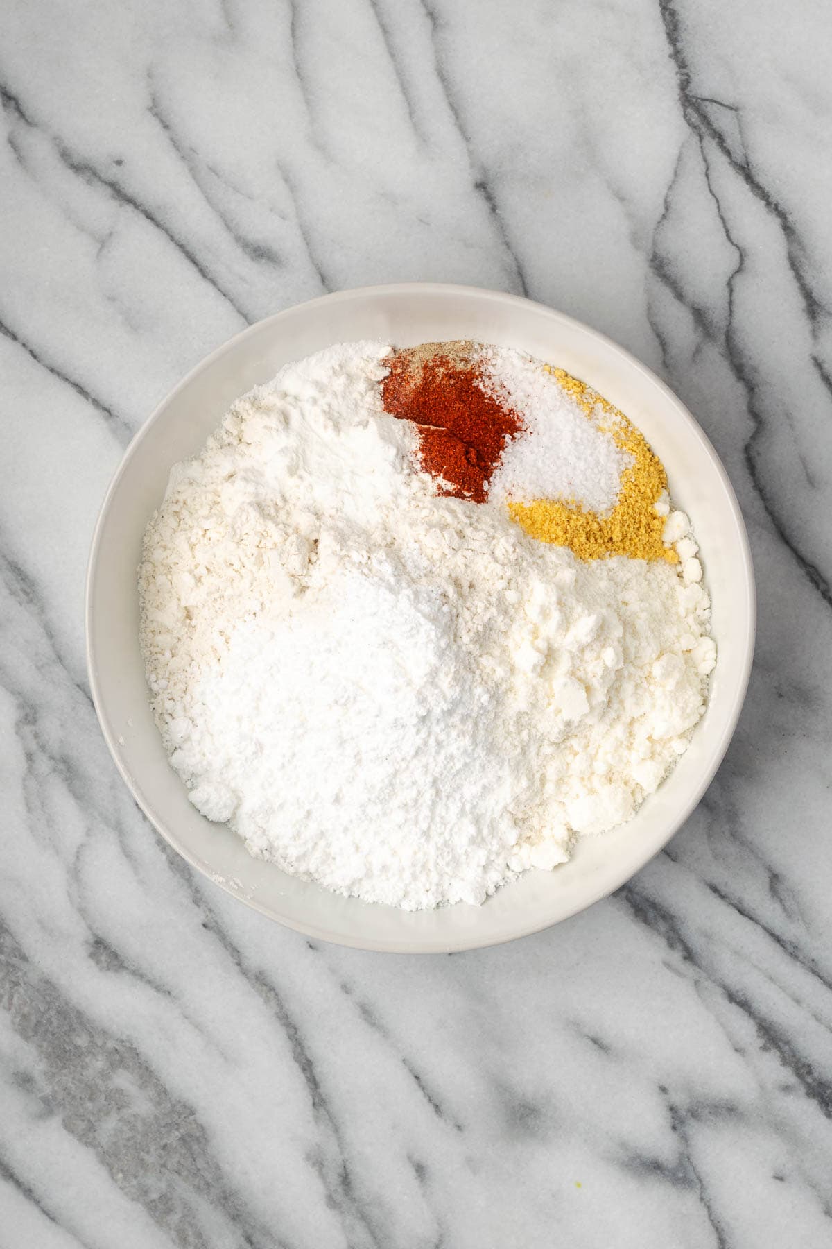Breading ingredients combined in a second shallow bowl.
