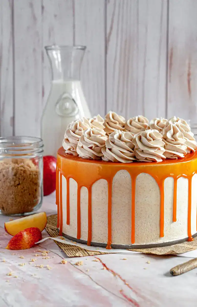 A gluten free apple layer cake frosted and covered with caramel.
