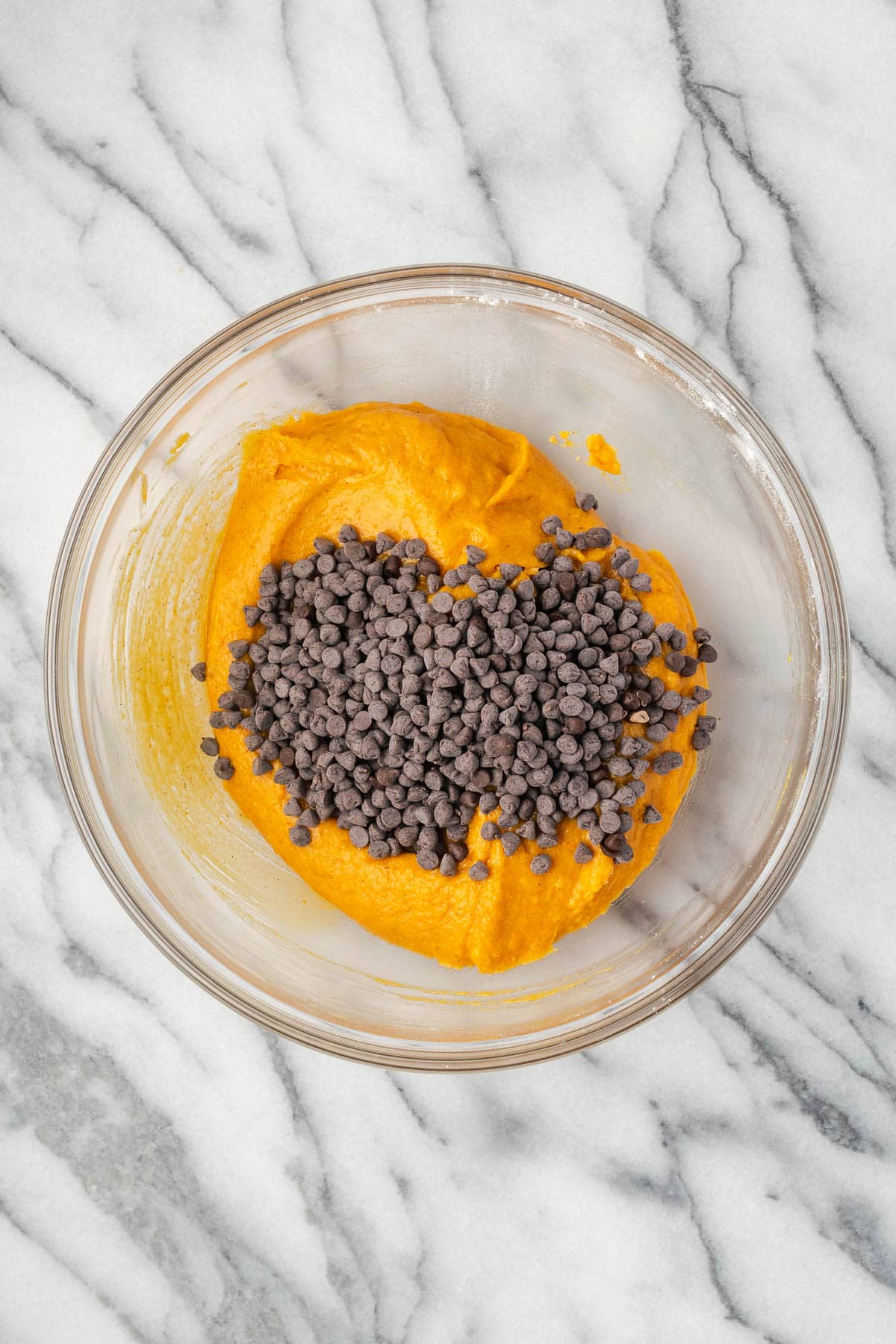 Mini chocolate chips added to the pumpkin muffin batter.