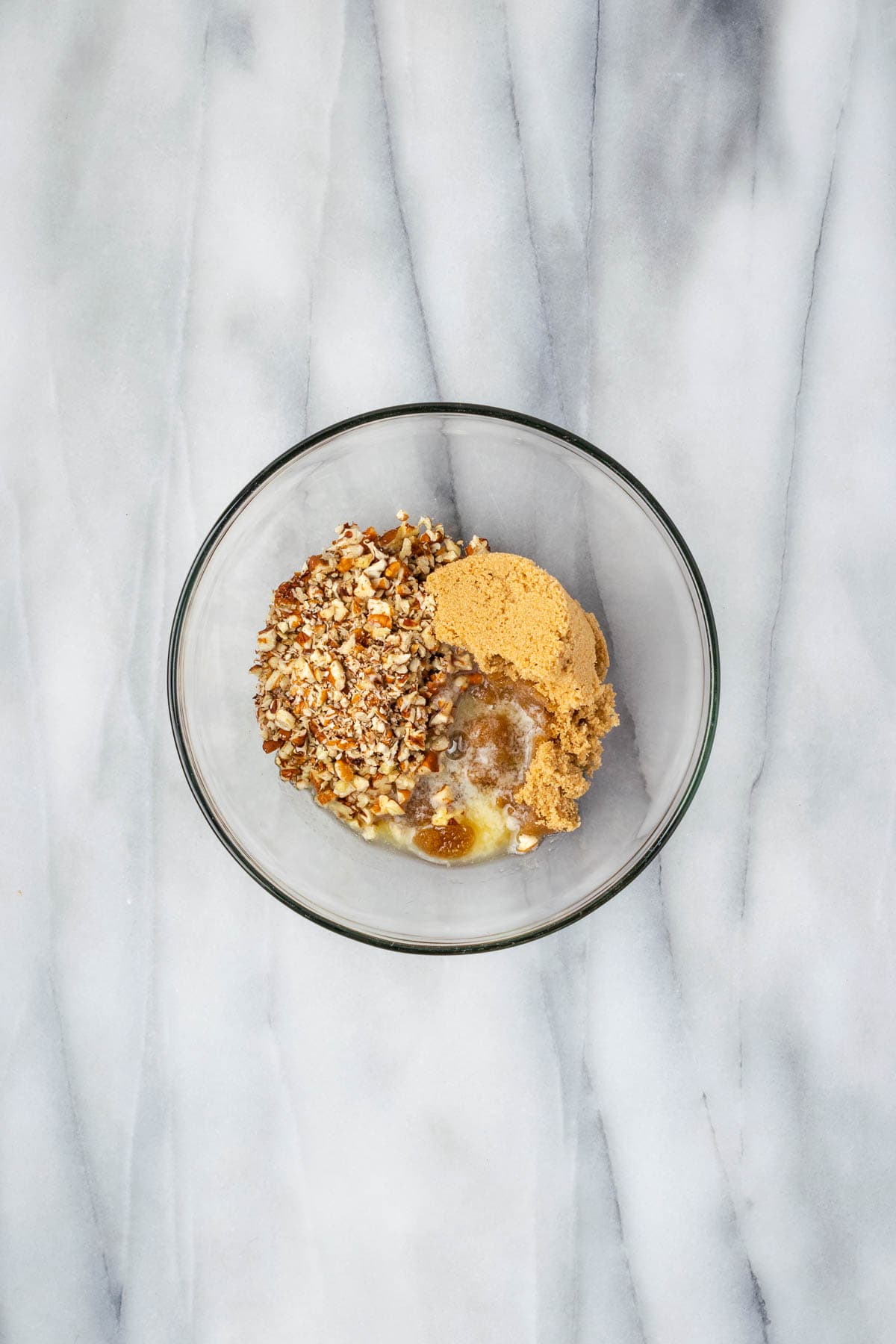 Brown sugar, chopped pecans, and melted butter combined in a small bowl. 