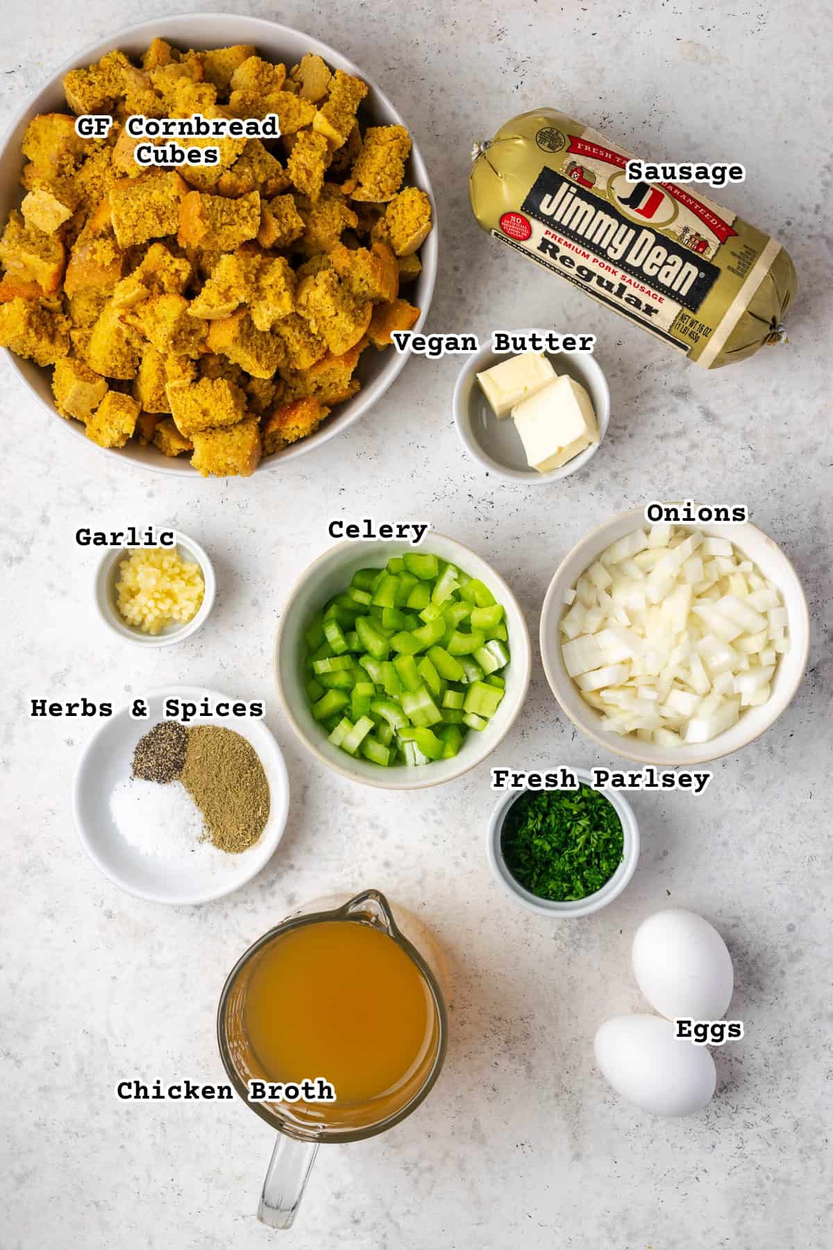 Ingredients for cornbread stuffing sitting on a white table. 