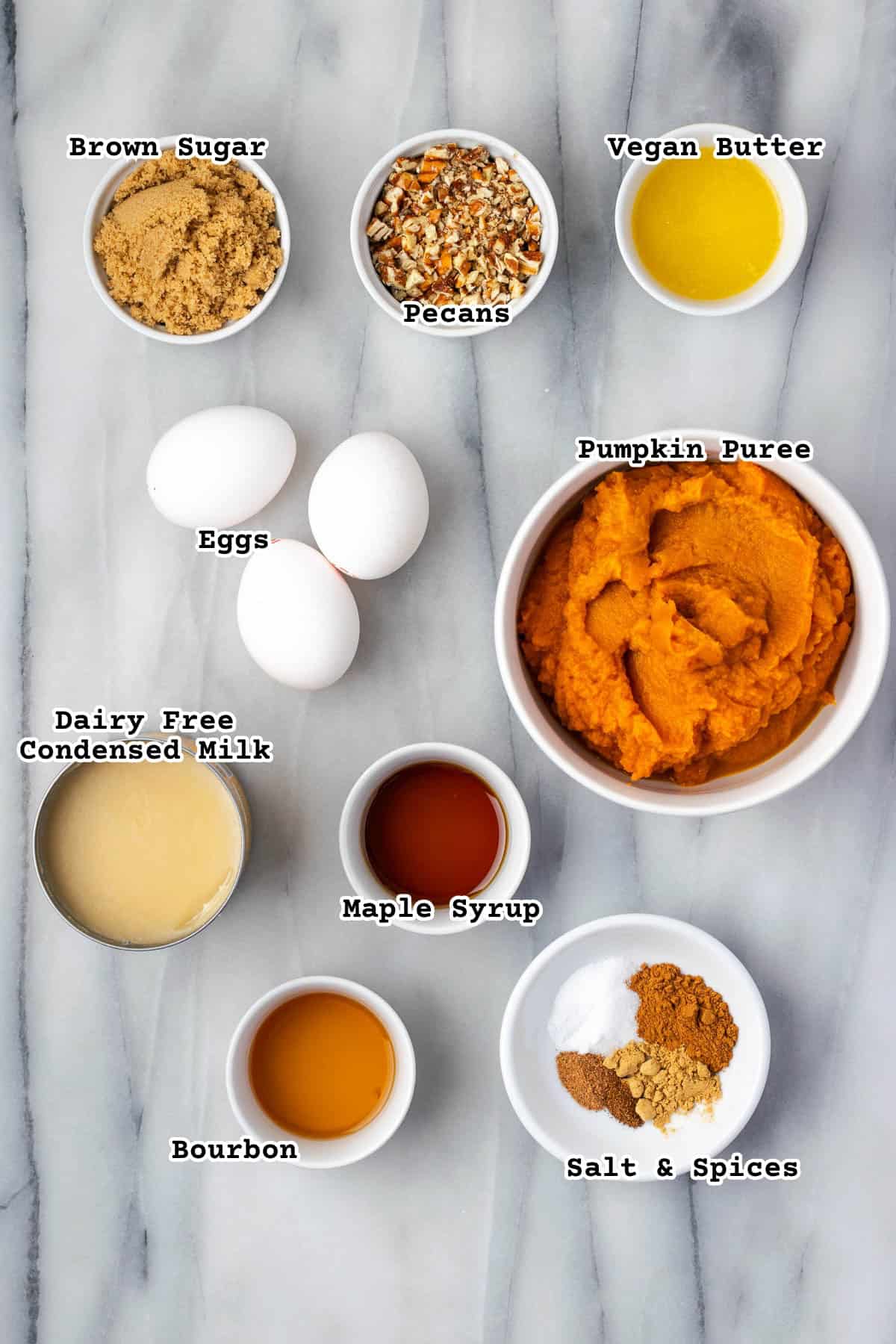 Ingredients for gluten free pumpkin pie on a marble counter.