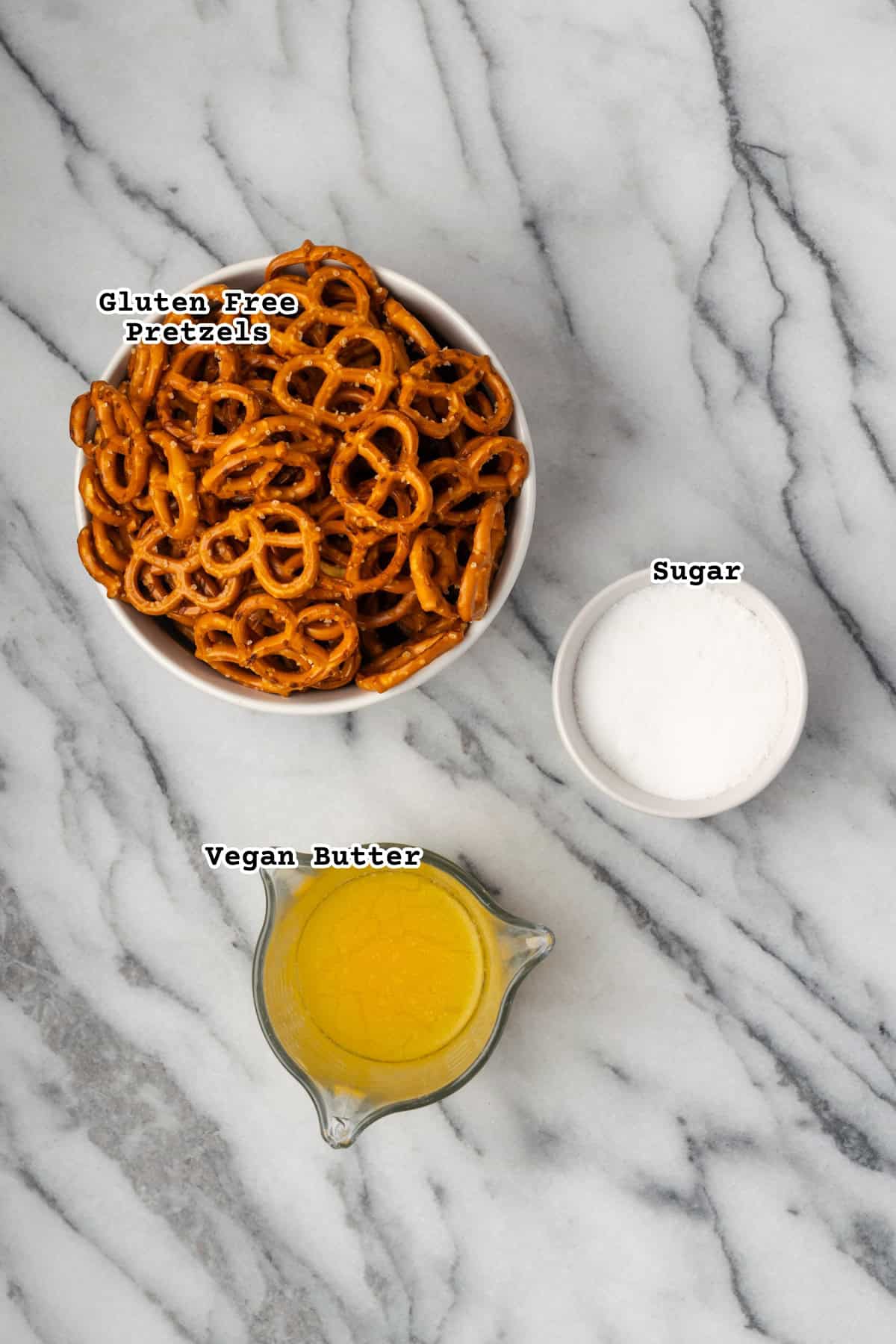 Ingredients for pretzel pie crust on a marble counter.