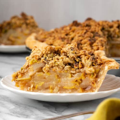 A slice of pear pie sitting on a small dessert plate.