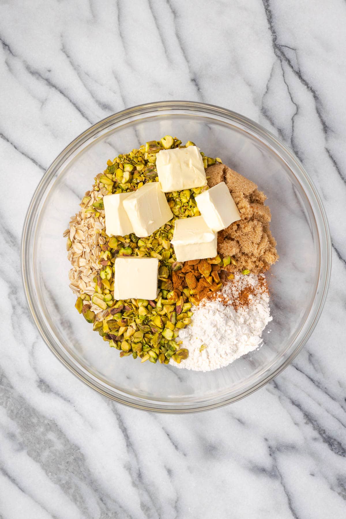 Oats, flour, brown sugar, cinnamon, salt, butter and chopped pistachios in a large bowl. 