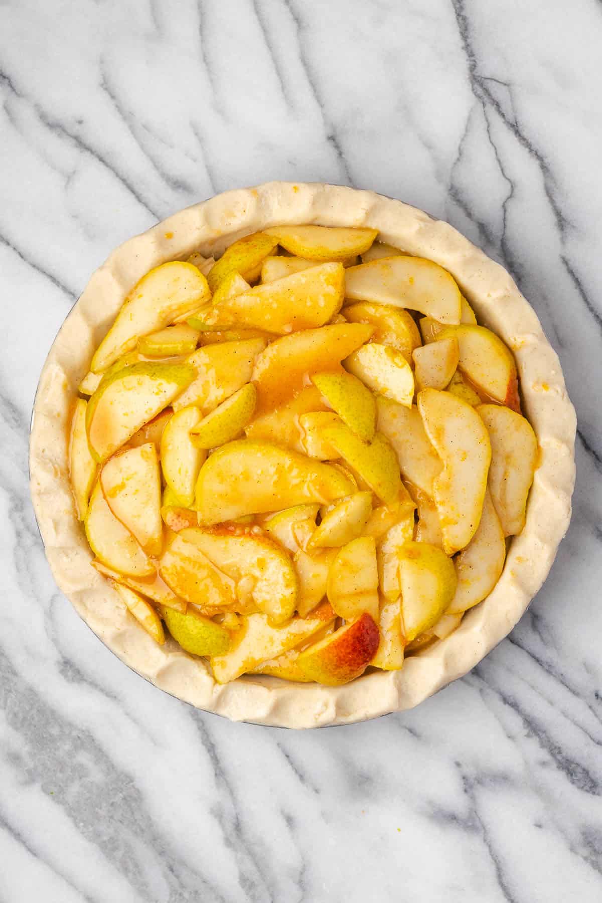 Pear pie filling in an unbaked pie shell. 