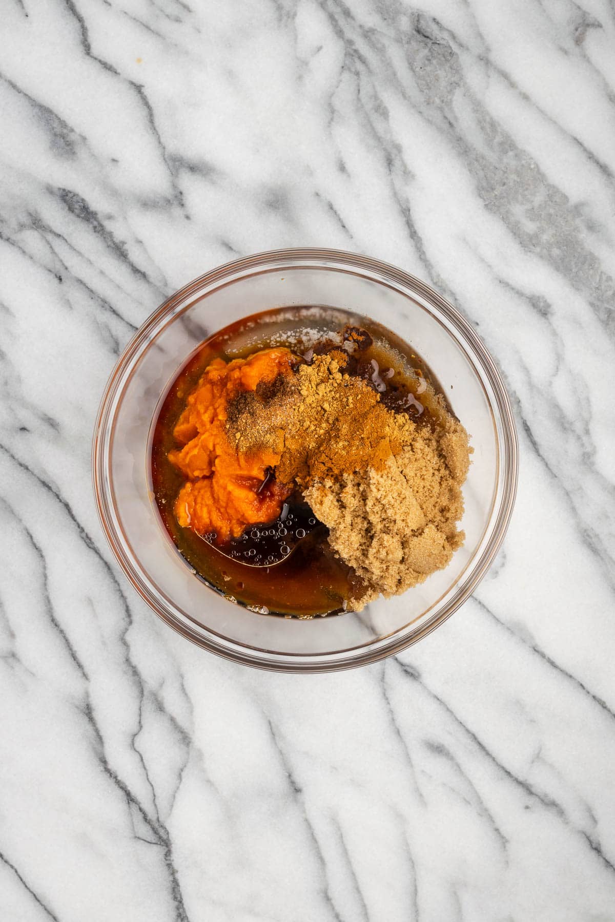 Pumpkin puree, brown sugar, maple syrup, coconut oil, vanilla, salt and spices combined in a small mixing bowl. 