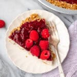 A slice of raspberry cream pie served on a small plate.